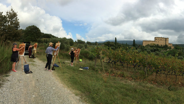 The Students paint outside with a view of the castle